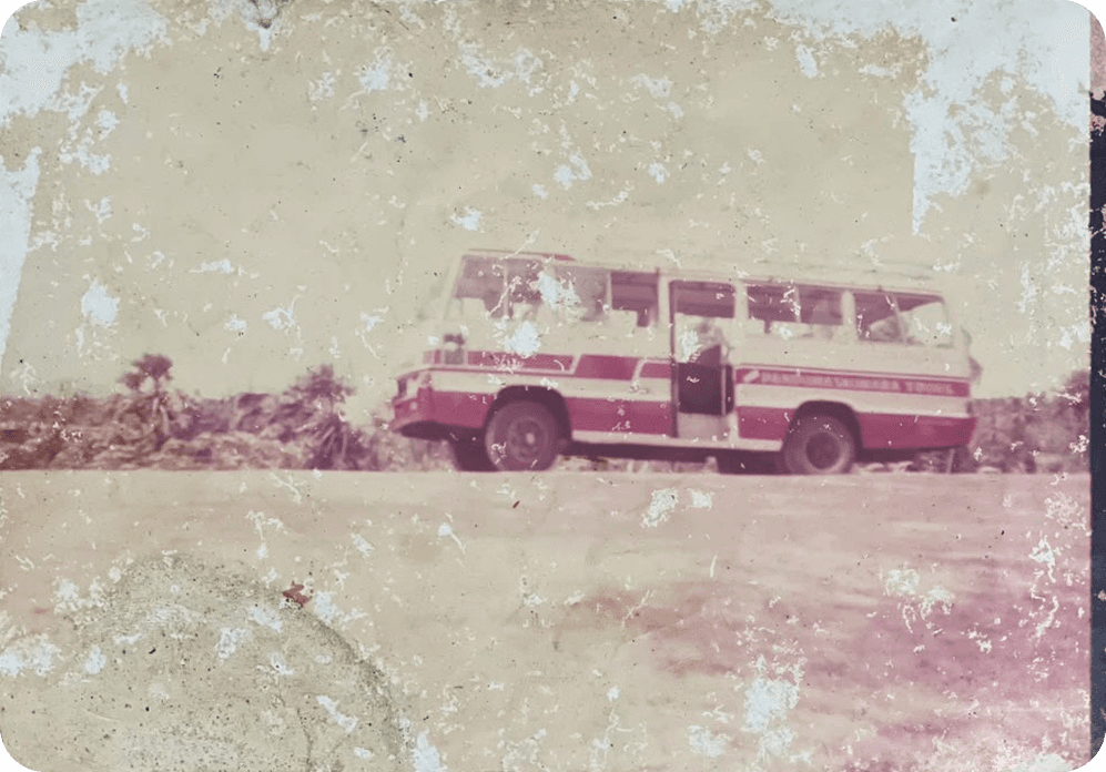 The original coach on the road, with Panduwasnuwara Tours painted along its side