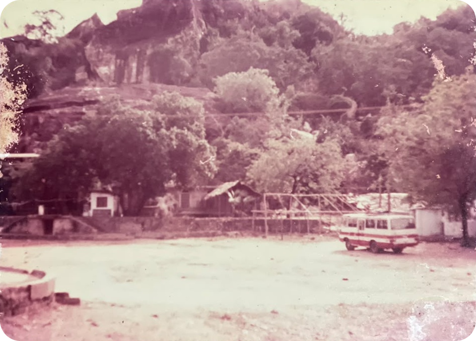 The original coach parked at the foot of a rock outcrop
