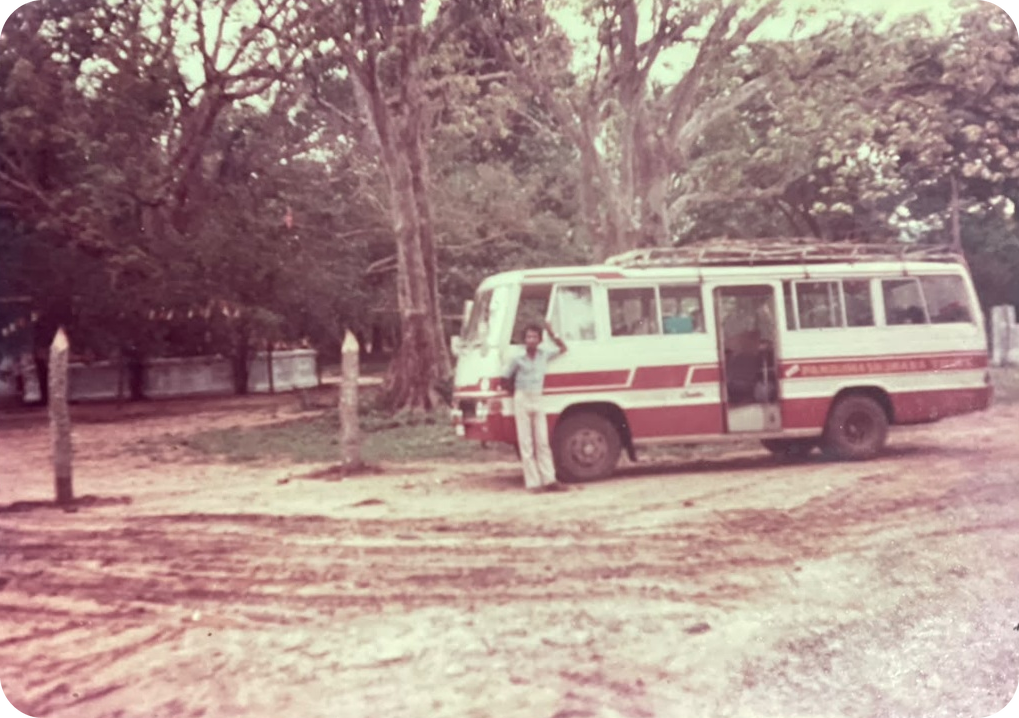 The founder of Panduwasnuwara Tours standing in front of the first coach, registration 29 Sri 3501